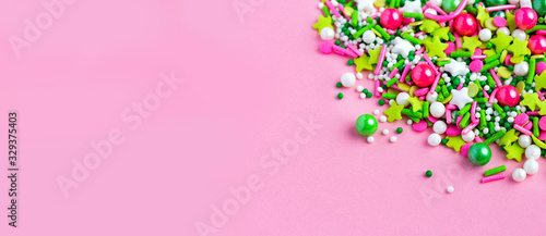 Multi-colored Sugar sprinkle dots, decoration for cake and bekery in pink background. Easter