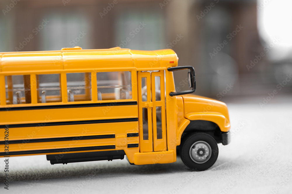 Yellow toy school bus against blurred