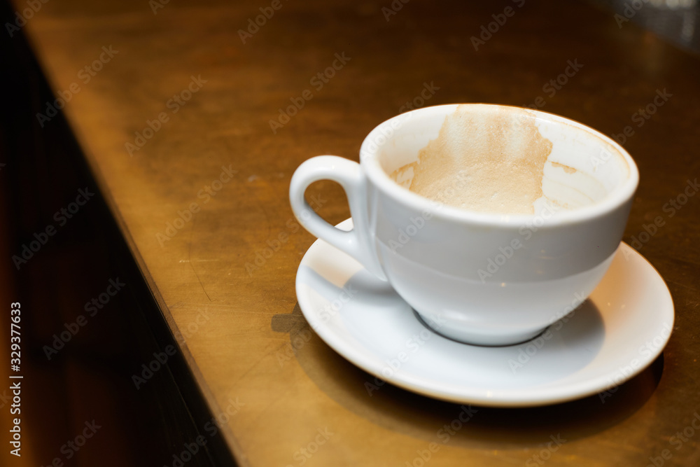 empty cup after coffee, slkdy coffee on a white cup, dirty cup on the bar empty cup after coffee, slkdy coffee on a white cup, dirty cup on the bar