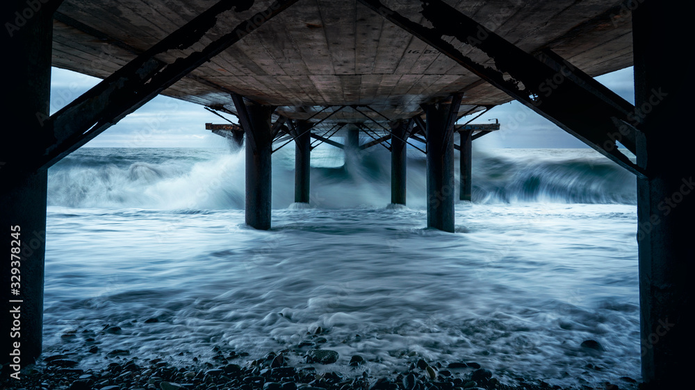 Waves from the sea bridge in the exposure under the