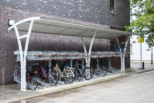 a two teir bike rack with bikes or cycles on both levels photo
