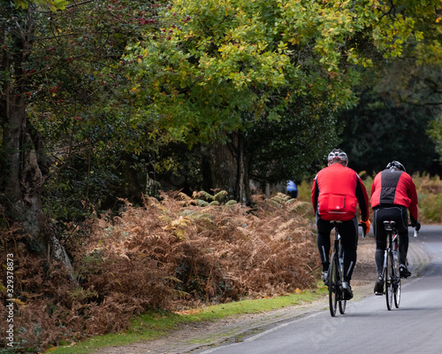  two cyclists riding on a countryside road in the new forest hampshire