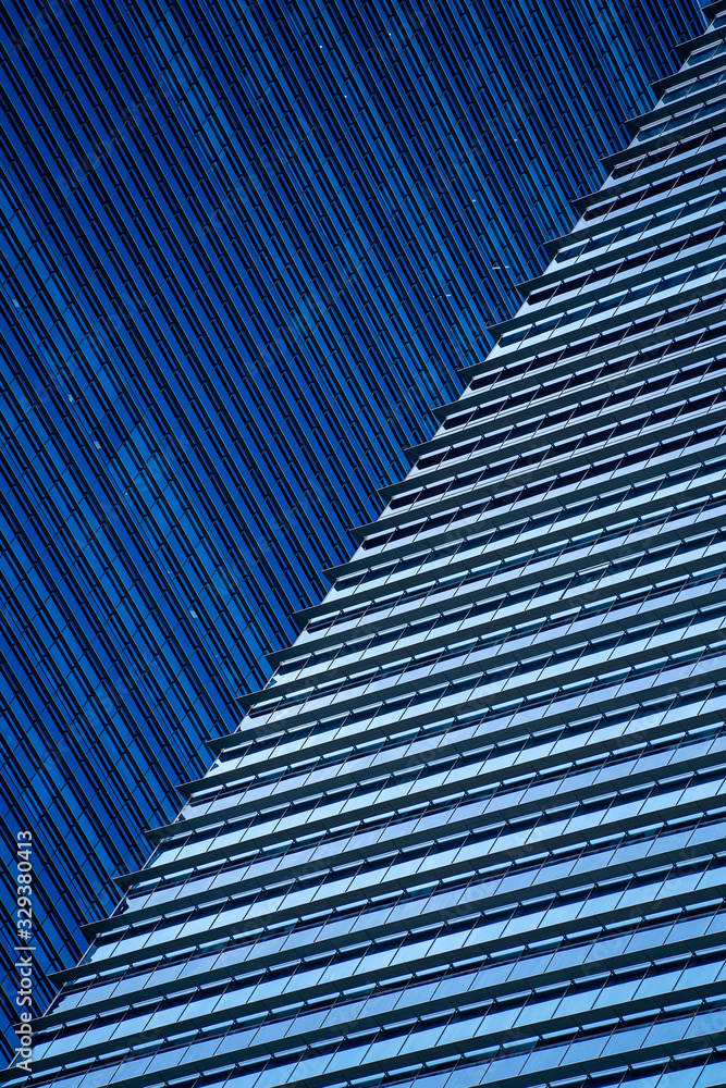 Naklejka premium High glass skyscrapers on the streets of Singapore. Office windows background, closeup