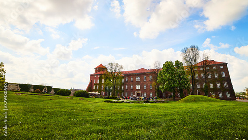 KRAKOW, POLAND - May 10, 2019: View on the inner courtyard of Wawel castle with garden and towers during the sunny morning in Krakow