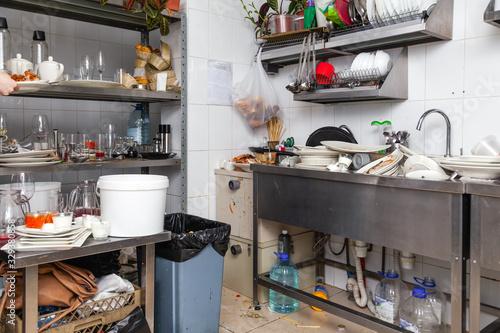 Photos Restaraunt kitchen full of dirty dishes, crockery, tableware