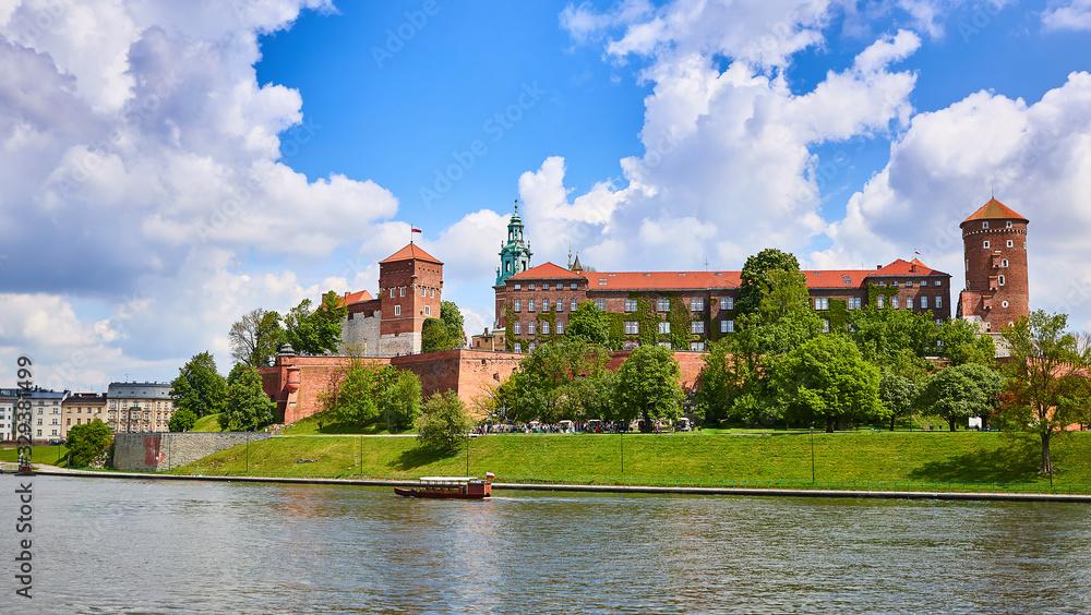 Wawel castle - famous landmark in Krakow Poland. Picturesque landscape on coast Vistula river during the sunny day.