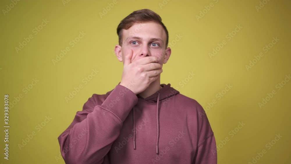 Man covering his mouth and trying not to say anything secret Man covering his mouth and trying not to say anything secret