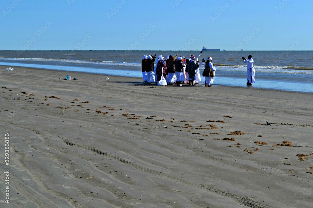 People praying on the beach in Galveston Island, Texas