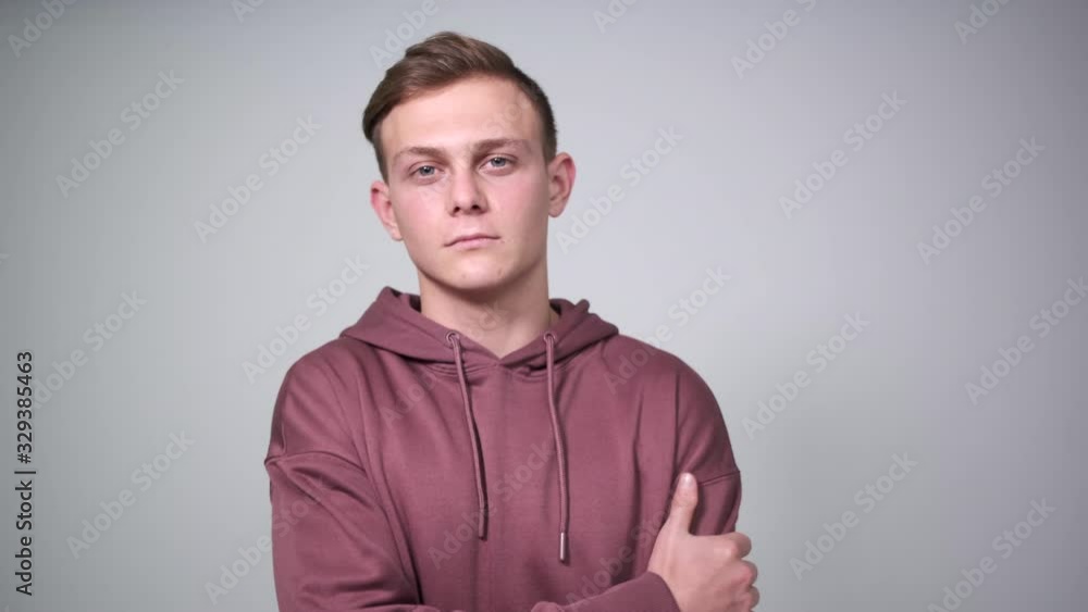Handsome man posing in hoodie over white background Handsome man posing in hoodie over white background