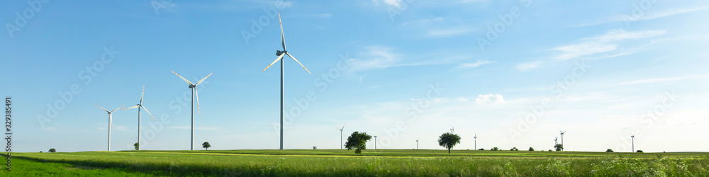 wind turbines in green field, countryside area with blue sky wind turbines in green field, countryside area with blue sky