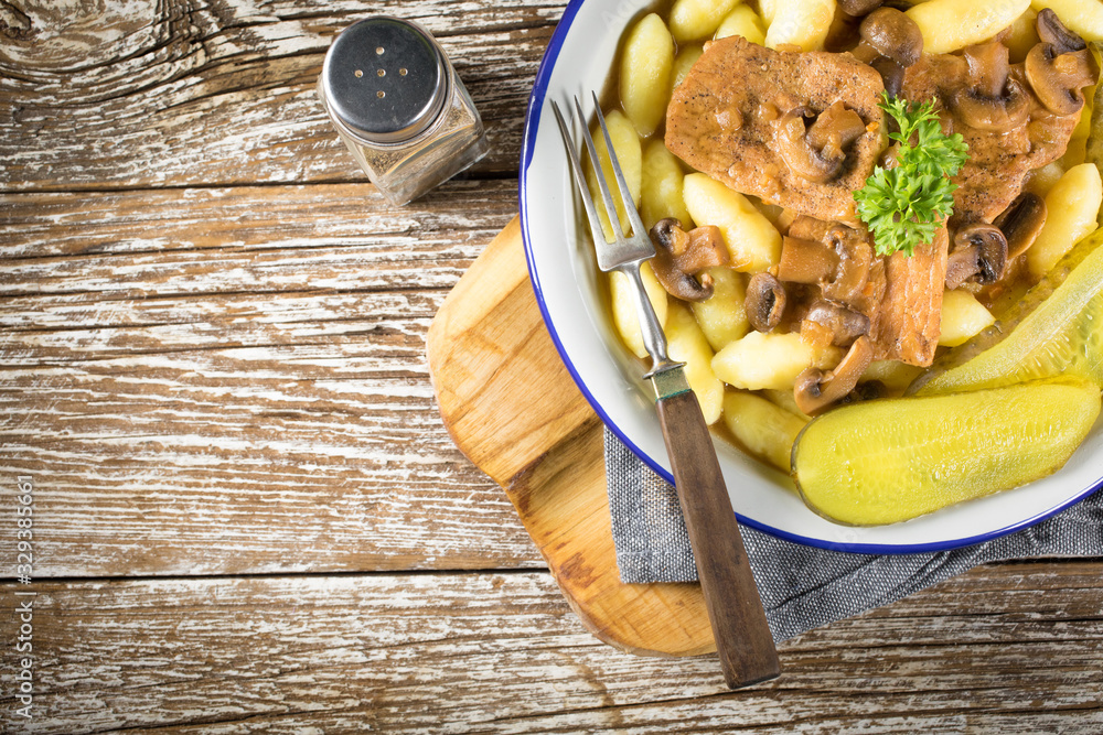 Braised pork loin with mushrooms. Stock Photo | Adobe Stock