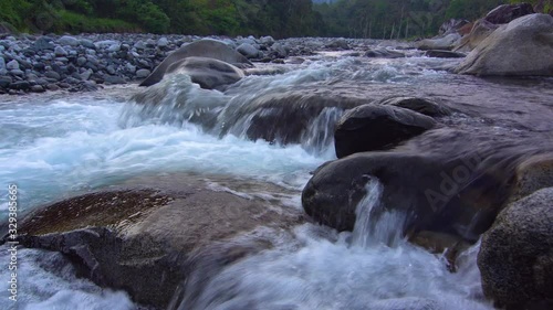 4K footage of Morning scenery river flow over the river on nature rural village. photo