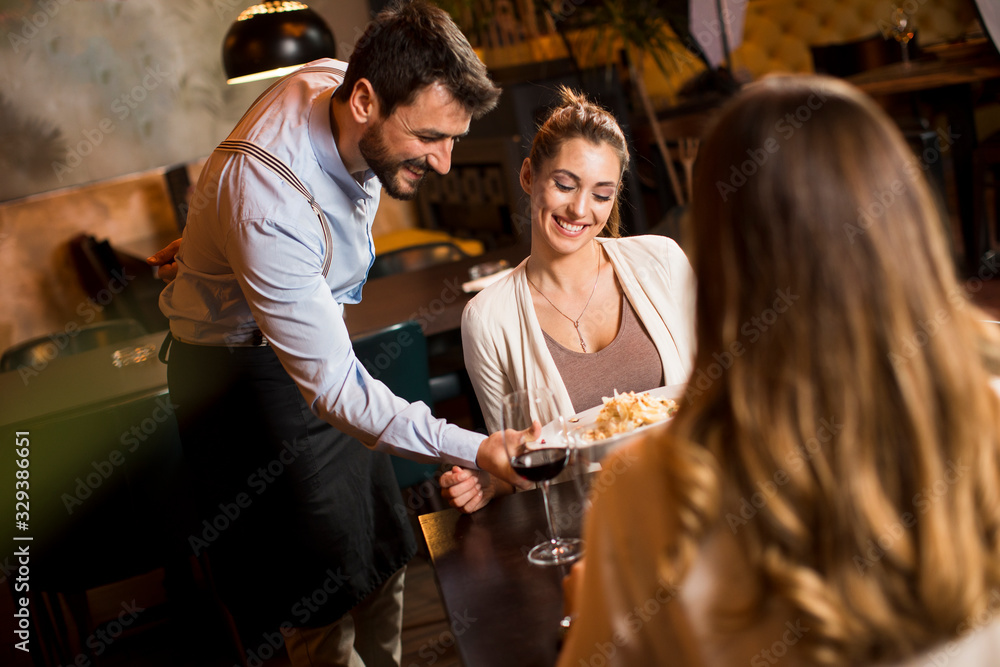 The waiter carries dishes