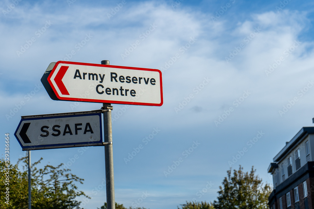 Fototapeta premium an army reserven centre sign and a SSAFA sign on a lamp post