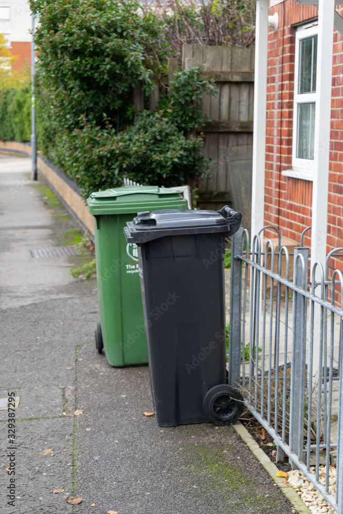 two recycling bins outside a home ready for collection two recycling bins outside a home ready for collection