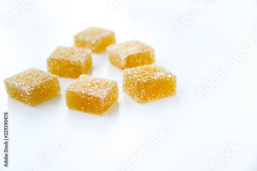 Pineapple, lemon, vanilla pate de fruit (jelly, marmalade, fruit candy) covered with sugar. White background, top view. 