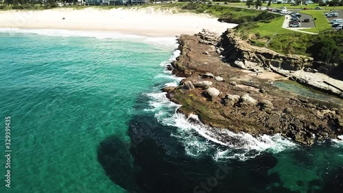 Wallpaper Mural Aerial shot of rocky shore being hit by ocean water, waves and making sea foam. Beautiful ocean in Australia. Torontodigital.ca