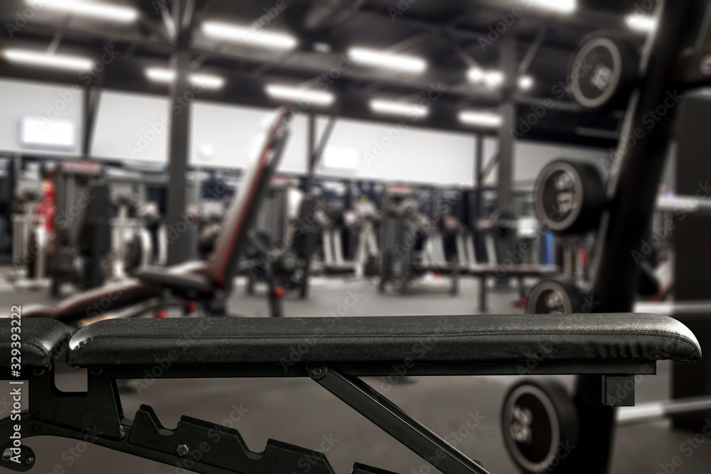 Gym interior and black bench. Dumbbells composition and free space for your decoration. Gym interior and black bench. Dumbbells composition and free space for your decoration.