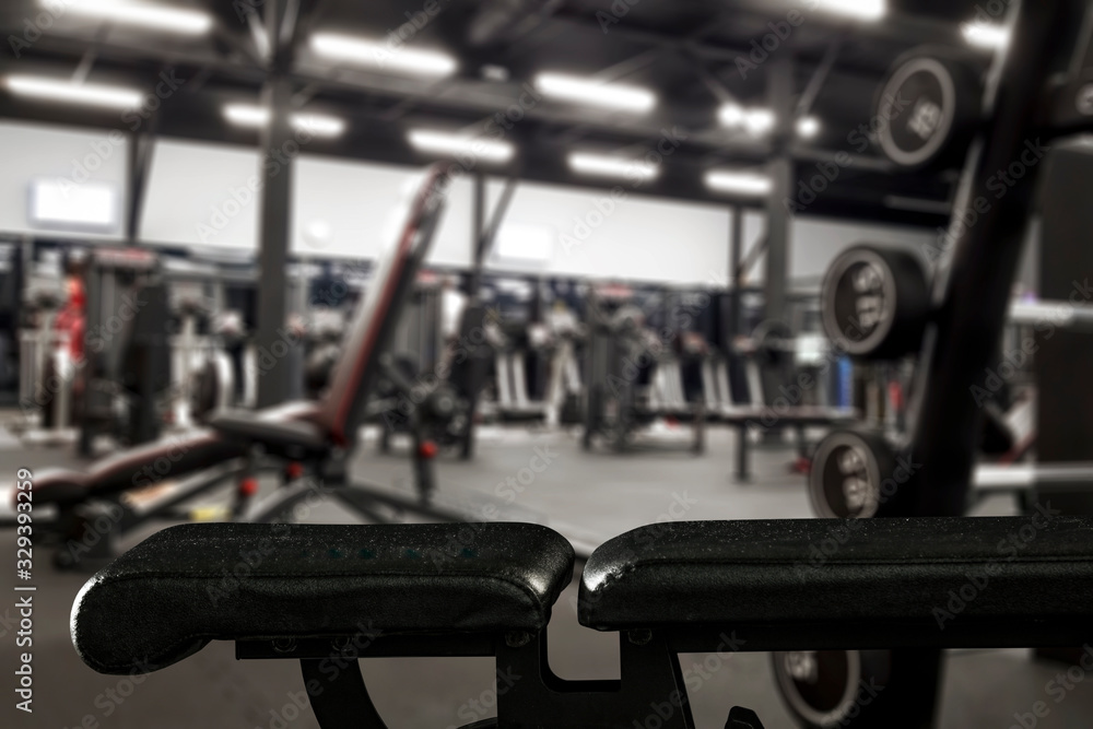 Fototapeta premium Gym interior and black bench. Dumbbells composition and free space for your decoration. 