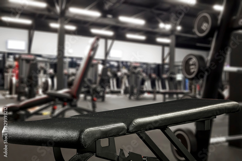 Gym interior and black bench. Dumbbells composition and free space for your decoration. 
