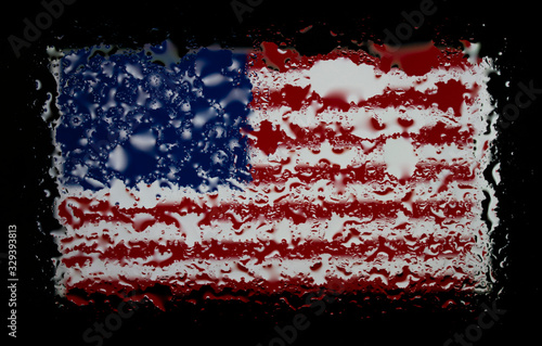 United States national flag. Abstract photo with raindrops on glass. Isolated on black background.