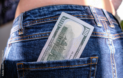 100 dollar bill in jeans pocket