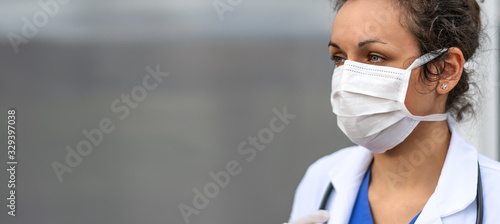 Biology and science. Doctor wearing protection face mask. Virus or bacteria cells. Global alert. Epidemic flu. Coronavirus. Medical staff preventive gear.