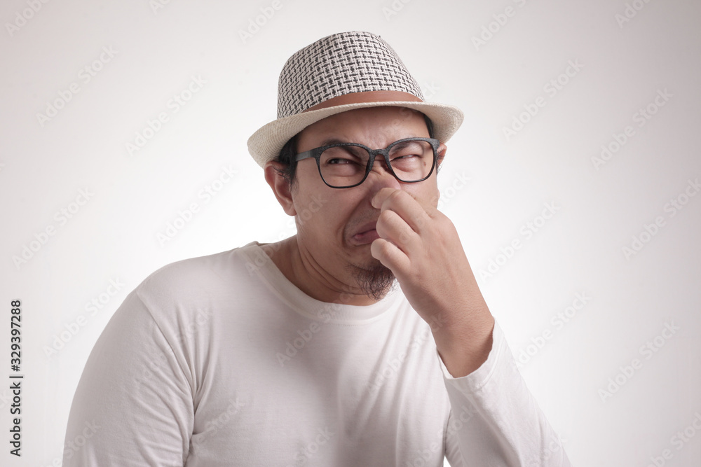 Young Man Close His Nose, Smells Something Bad Young Man Close His Nose, Smells Something Bad