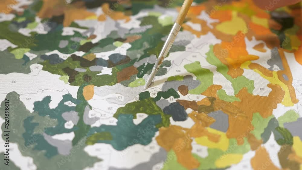 Close up of the picture by numbers. Brush with blue paint. Close up of the picture by numbers. Brush with blue paint.