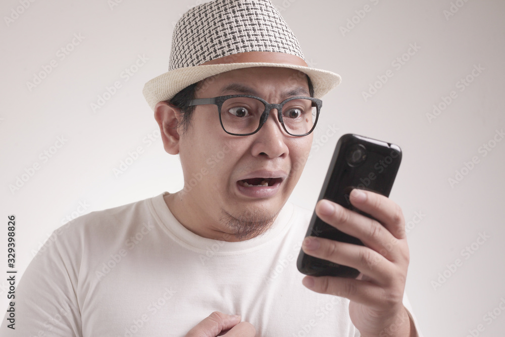 Young Man Texting Reading Chatting on His Phone Sad Crying Young Man Texting Reading Chatting on His Phone Sad Crying