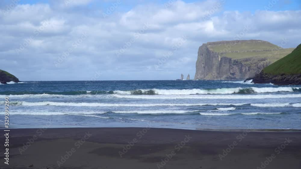 Risin and Kellingin rocks as seen from Tjornuvik bay with waves hitting the shore on Streymoy on the Faroe Islands, Denmark, Europe Risin and Kellingin rocks as seen from Tjornuvik bay with waves hitting the shore on Streymoy on the Faroe Islands, Denmark, Europe