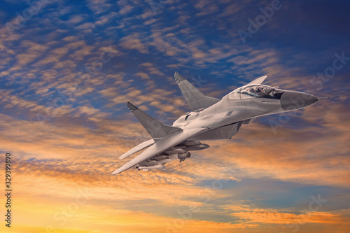Climbing military combat fighter jet against the backdrop of sunset clouds and sky.