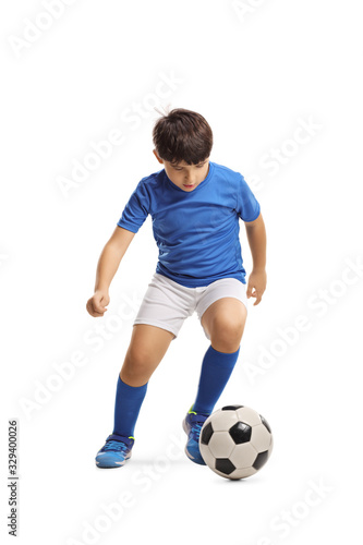 Boy in a sports jersey running with a football