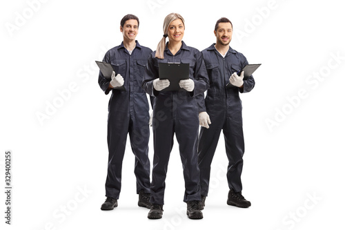 Foto One female and two male workers in overall uniforms