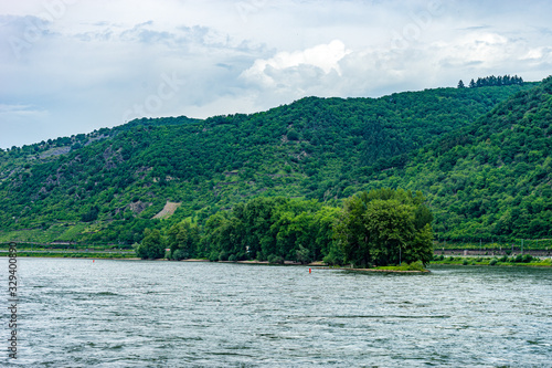Germany, Rhine Romantic Cruise, a large body of water with a mountain in the background © SkandaRamana