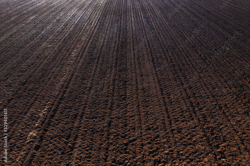 Fototapeta premium Aerial view of plowed and irrigated farm land