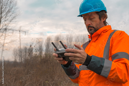 Forestry technician flying a drone with remote controller