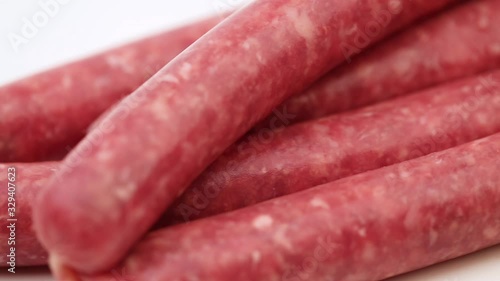 Raw beef sausages close-up. Raw sausages for grilling on a close-up on a white background.