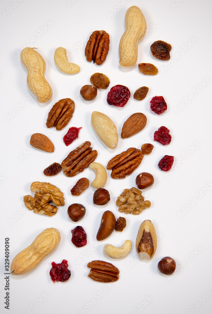 Mixed nuts and dried fruits in wooden bowl on white background, copy space Mixed nuts and dried fruits in wooden bowl on white background, copy space