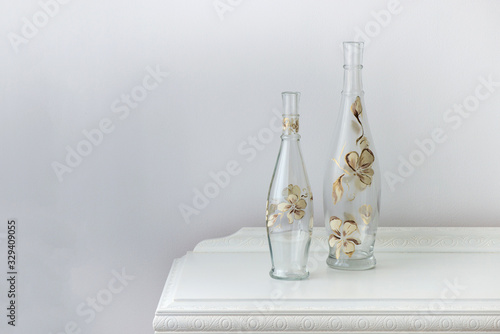 painted glass bottle over an antique wooden cabinet - home decoration - selective focus, copy space