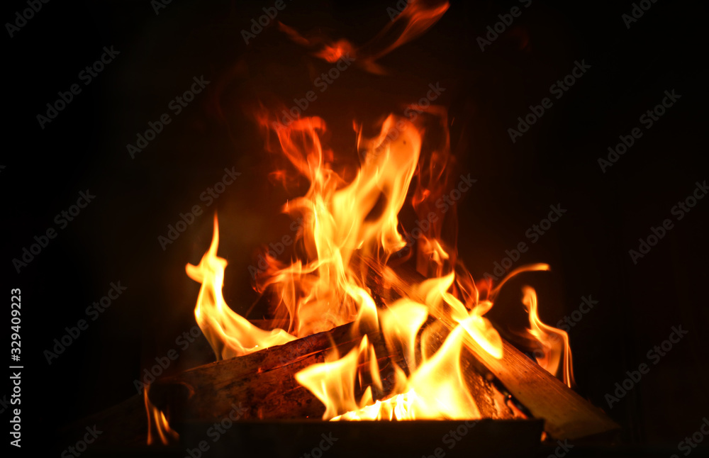 Obraz premium Fireplace with burning wood, closeup view. Winter vacation