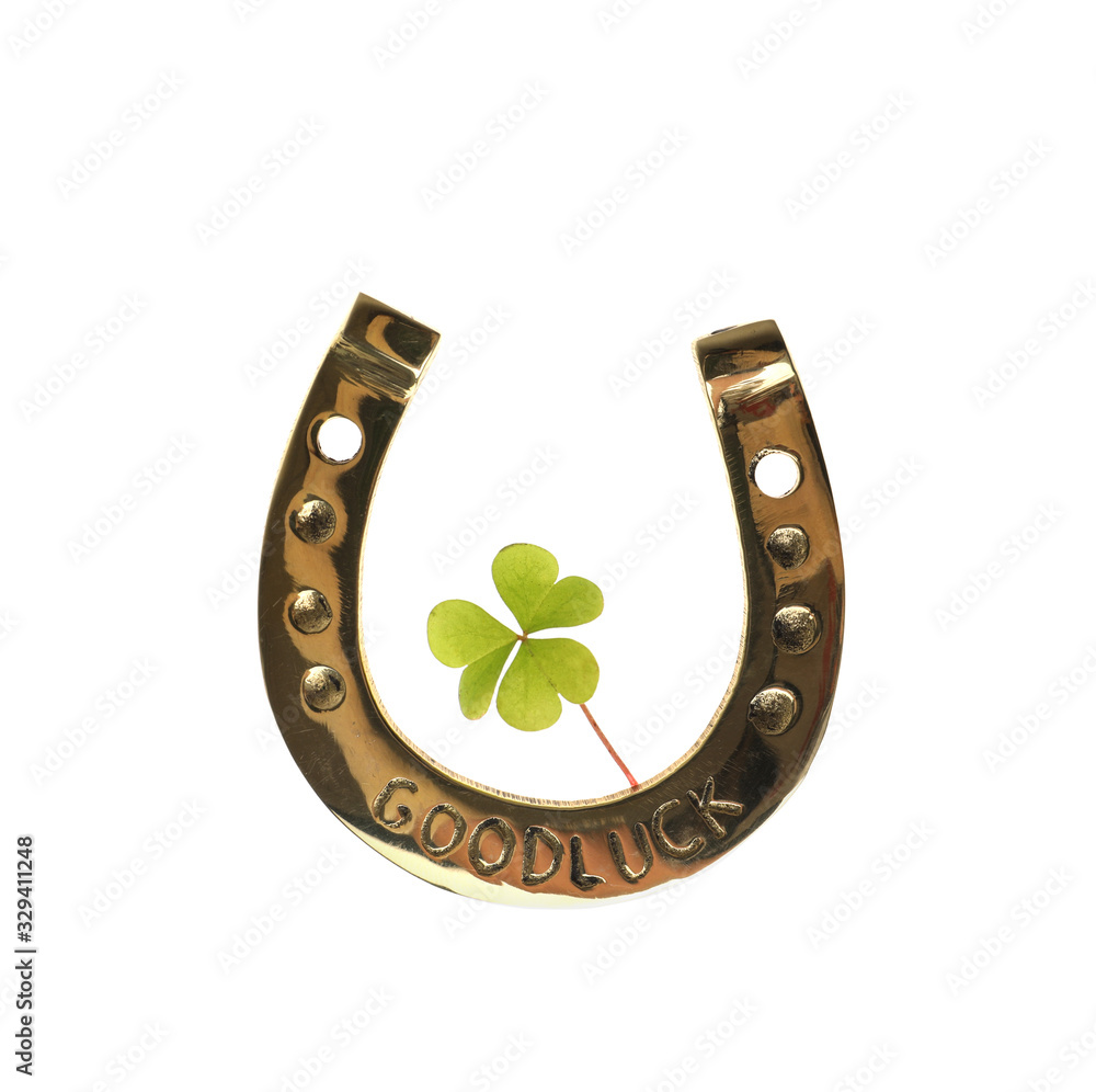 Golden horseshoe with phrase GOOD LUCK and clover on white background. St. Patrick's Day celebration Golden horseshoe with phrase GOOD LUCK and clover on white background. St. Patrick's Day celebration