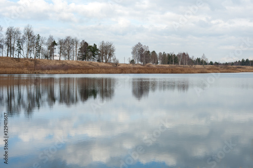 reflection in the water of trees and sky