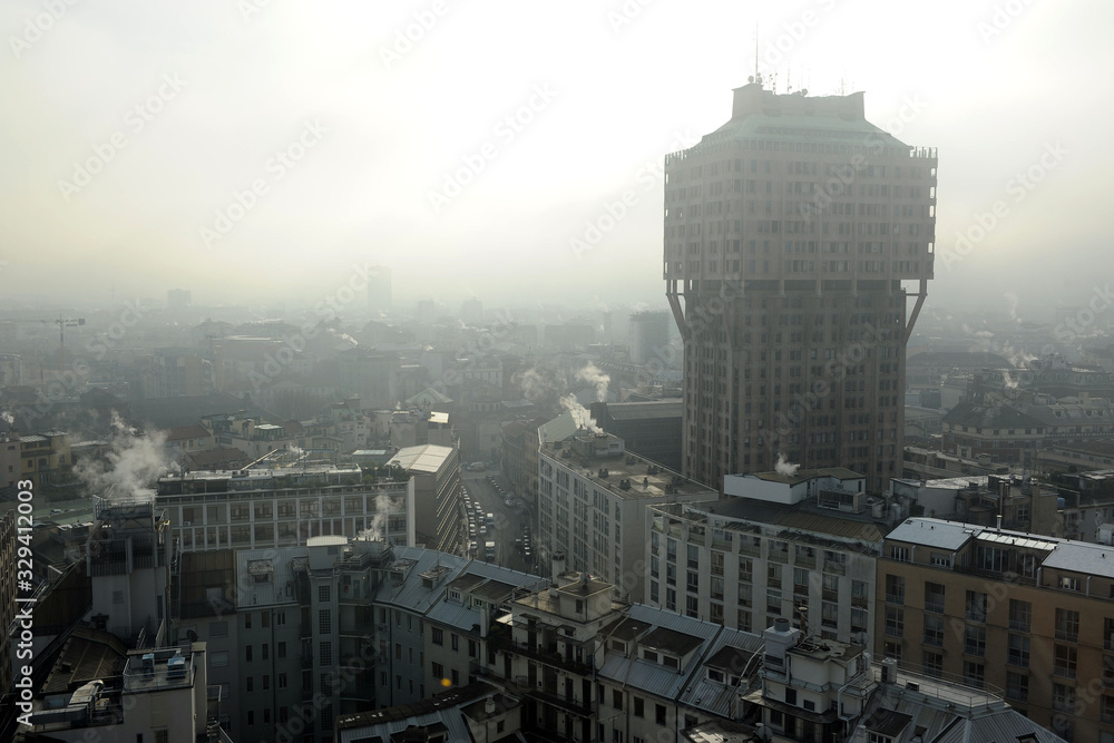 Milan - smog and atmospheric pollution pm10 - smoke from the heating of houses comes out from chimney pots - co2