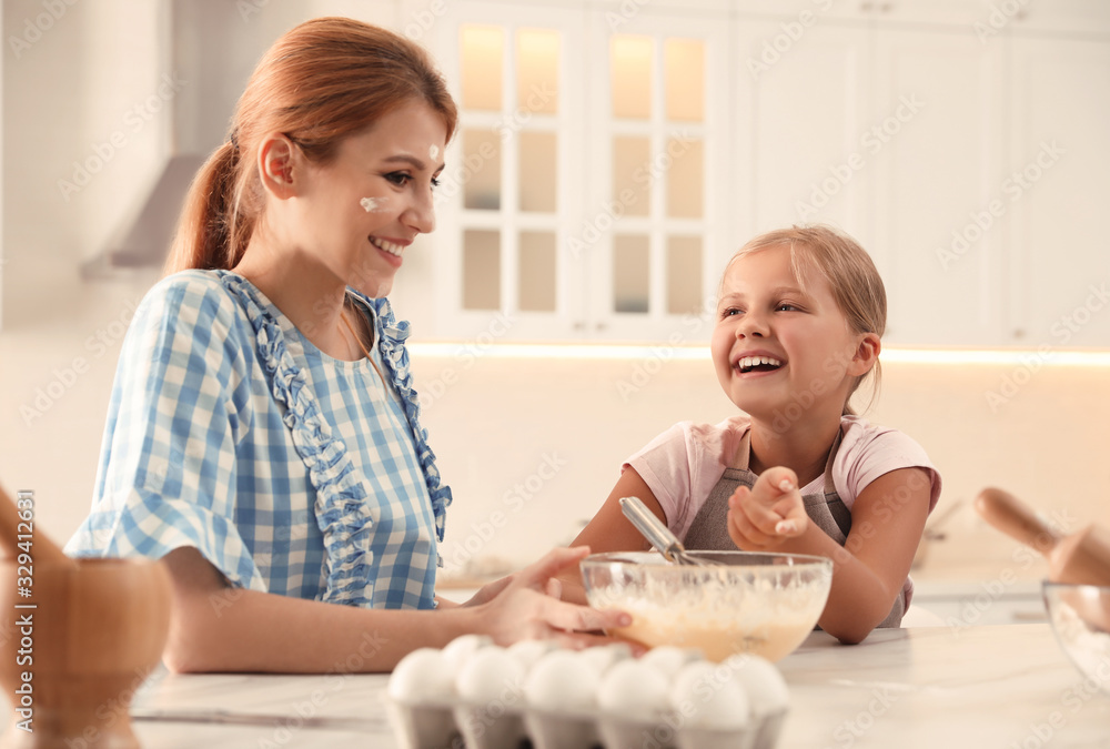 Mother and daughter making dough together in kitchen Mother and daughter making dough together in kitchen