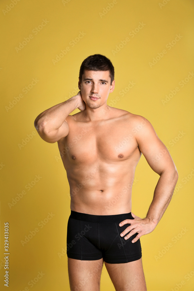 Man with sexy body on yellow background