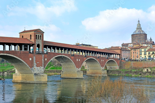 Pavia, Italy. february14,2018. The Ponte Coperto ("covered bridge") or the Ponte Vecchio ("Old Bridge") is a brick and stone arch bridge over the Ticino River in Pavia, Italy. Duomo di Pavia visible © andrea