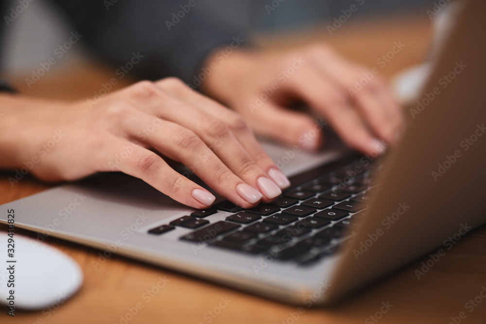 Woman working on modern laptop at table, closeup Woman working on modern laptop at table, closeup