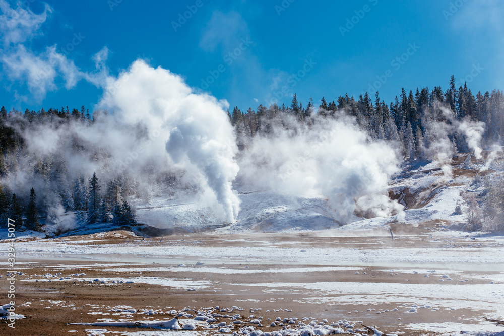 Colorful Porcelain Basin area trail with steaming vents and fumaroles in Yellowstone National Park, Wyoming, USA