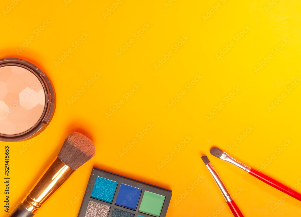 Set of decorative cosmetics on yellow background. Make up concept. Copy space image for your text Set of decorative cosmetics on yellow background. Make up concept. Copy space image for your text